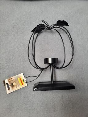 Metal Pumpkin-Shaped Candle Holder With A Wire Frame and Leaf Accent